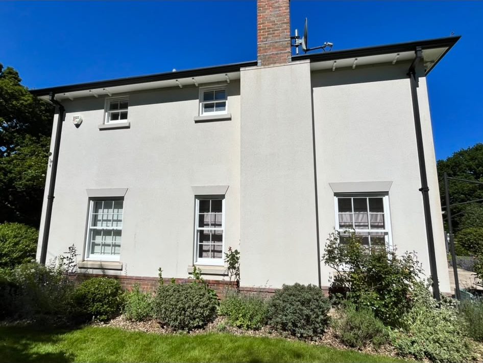 Clean rendered two-storey house after render cleaning in Lymington