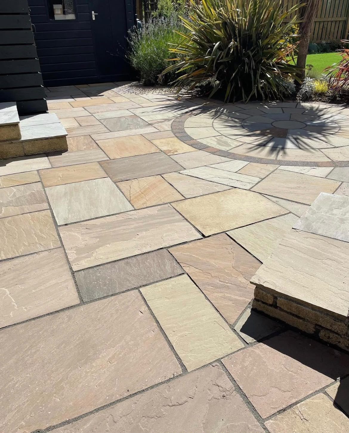 Clean sandstone patio with circle feature after patio cleaning in Lymington