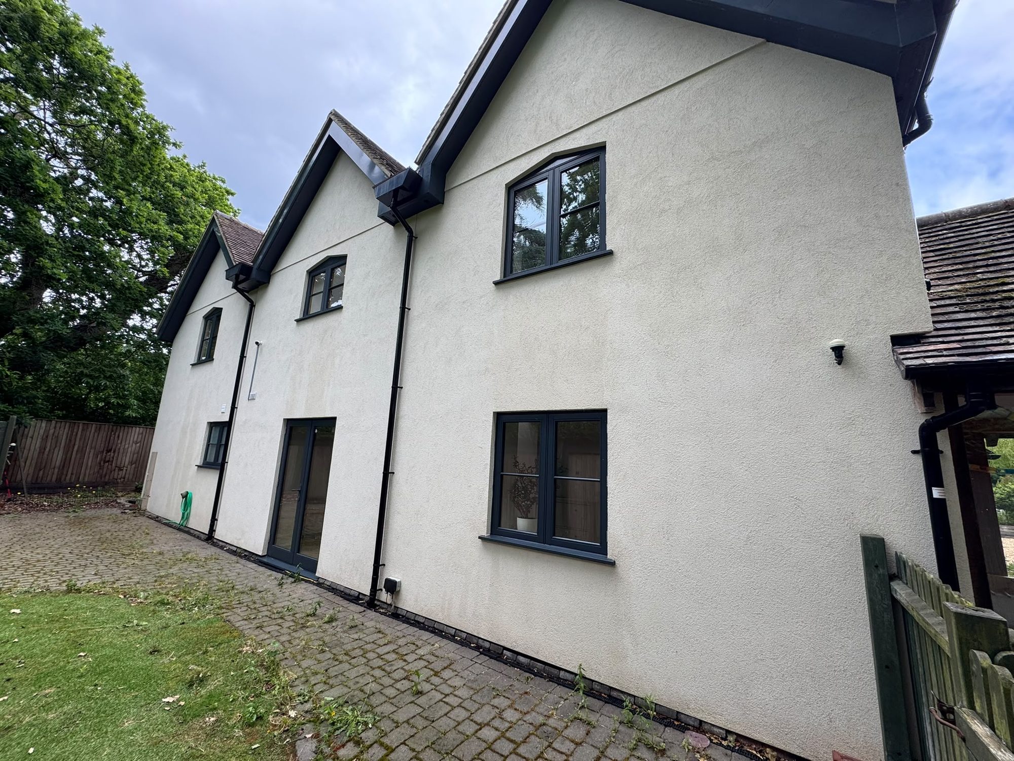 Rendered house wall after render cleaning in Lymington