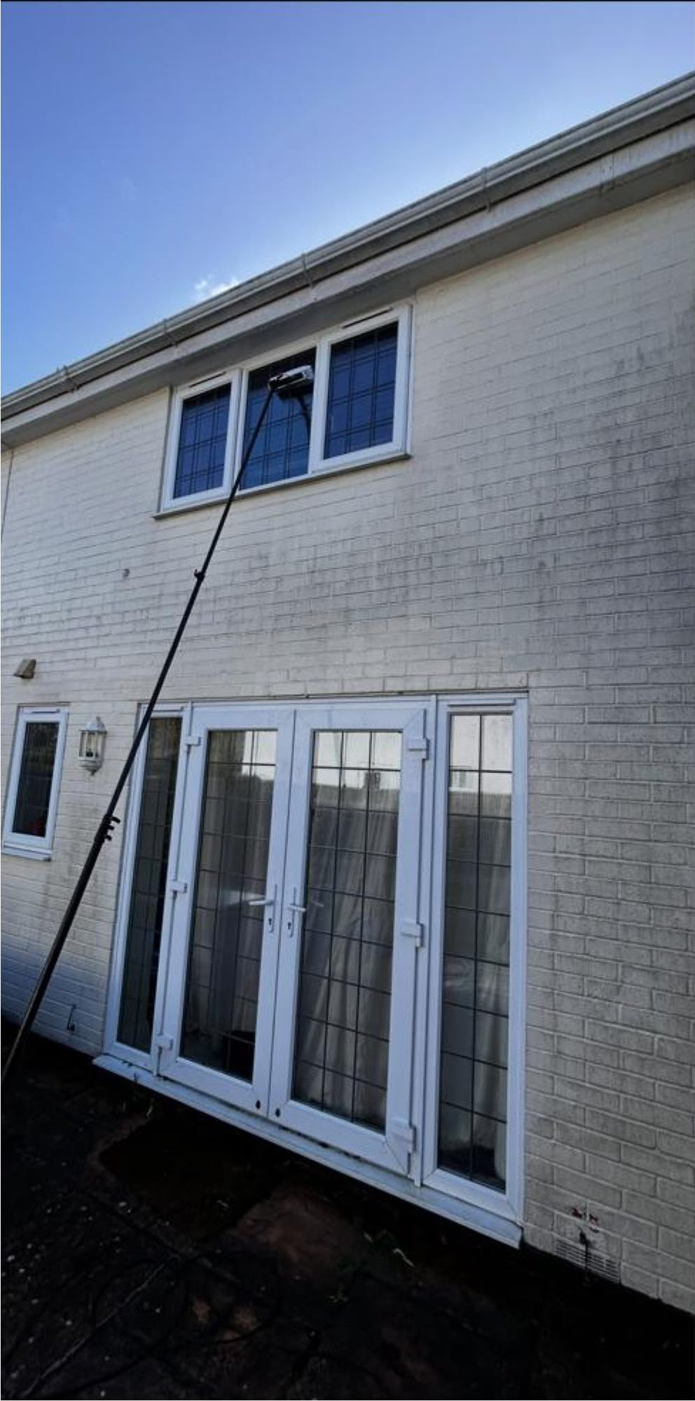 Soft washing before and after on painted brick walls in Lymington - before