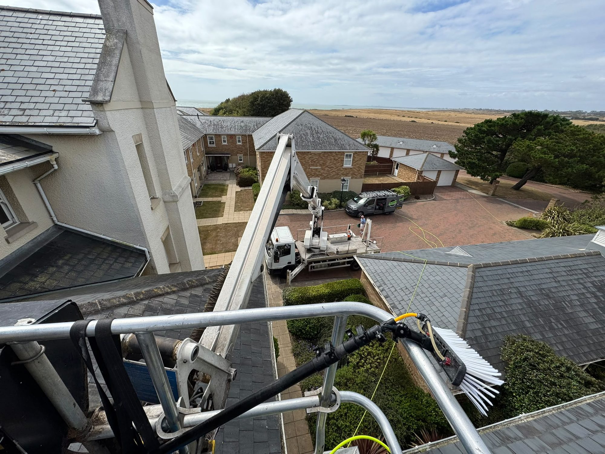 High-level cleaning access rig above rooftops in Lymington
