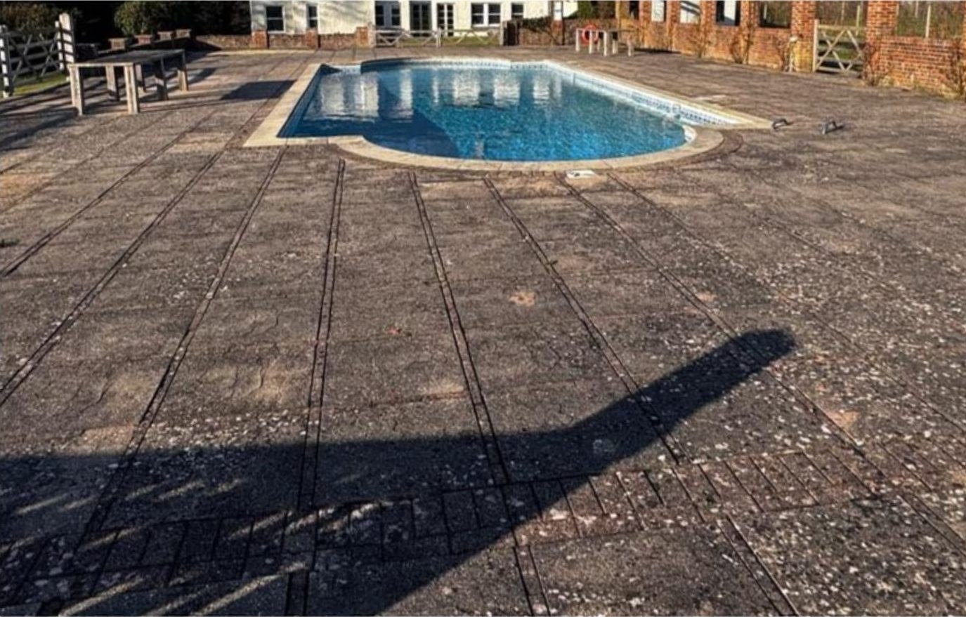 Pool surround patio jet washing before and after in Lymington - before