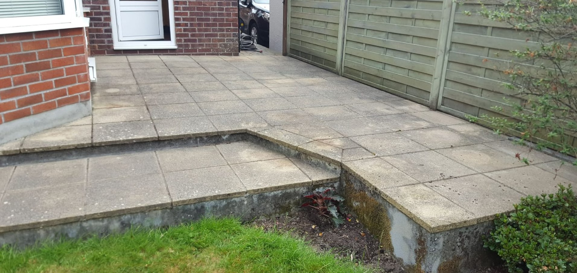 Stepped garden patio pressure washing before and after in Lymington - before